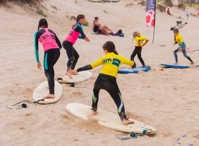 Surfista ensayando la postura en la arena